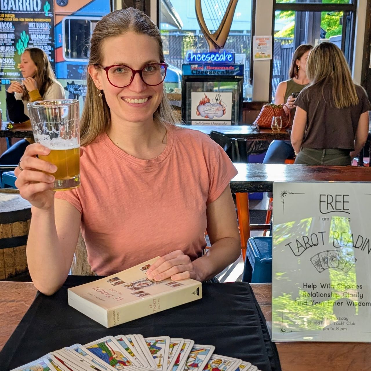 Flo at Midtown Yacht Club in Bend, Oregon, with her French Tarot cards spread out on the table